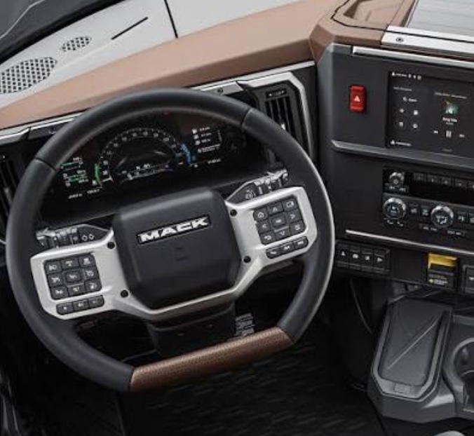 Production Mack truck cab interior: steering wheel with button clusters, digital gauge cluster and center touchscreen